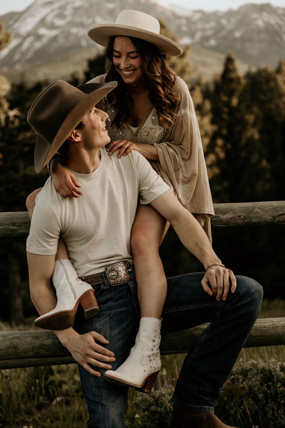 Cowboy themed couples photography session capturing love and adventure against a mountain rustic backdrop