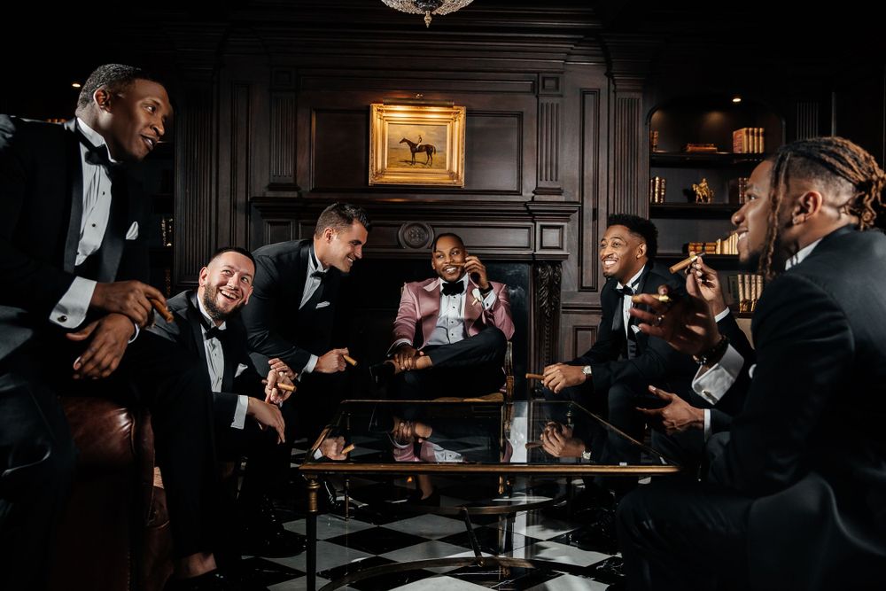 Classic groom’s party gathering in a stylish, vintage-inspired lounge, enjoying a celebratory toast before the ceremony.