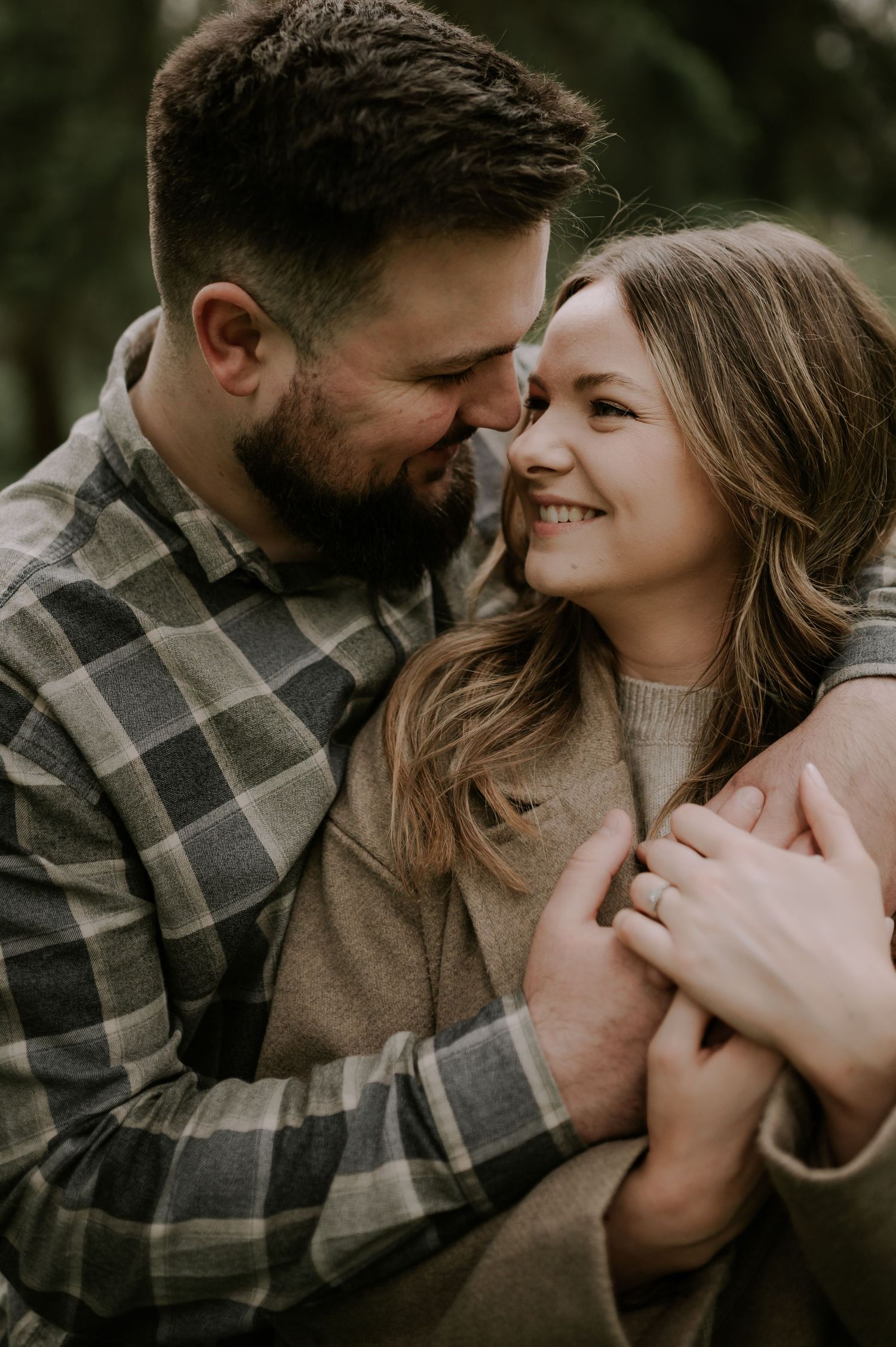 A cozy intimate moment shared between a couple wearing plaid and sweaters during autumn.
