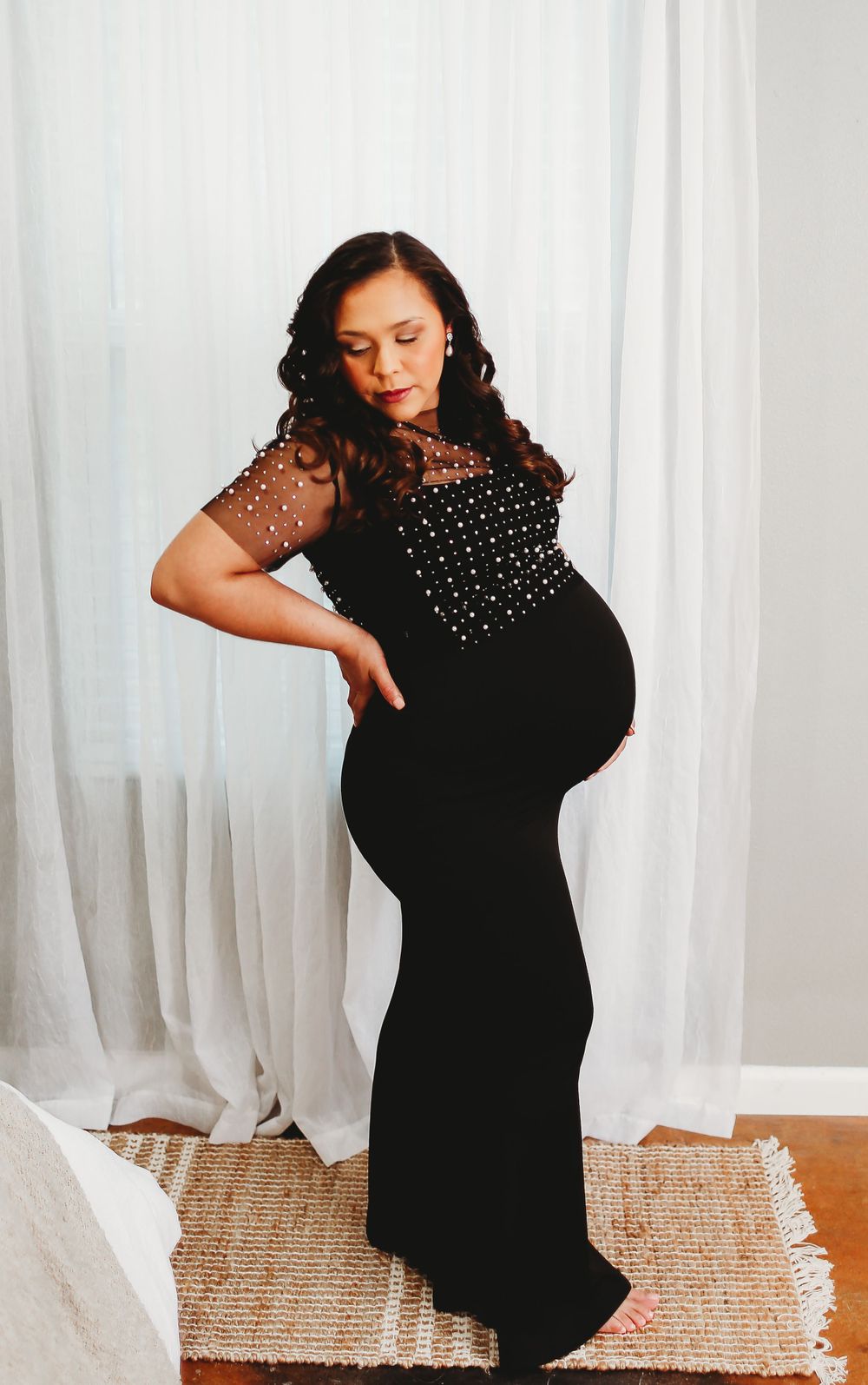 Mama in studio for maternity session wearing black dress
