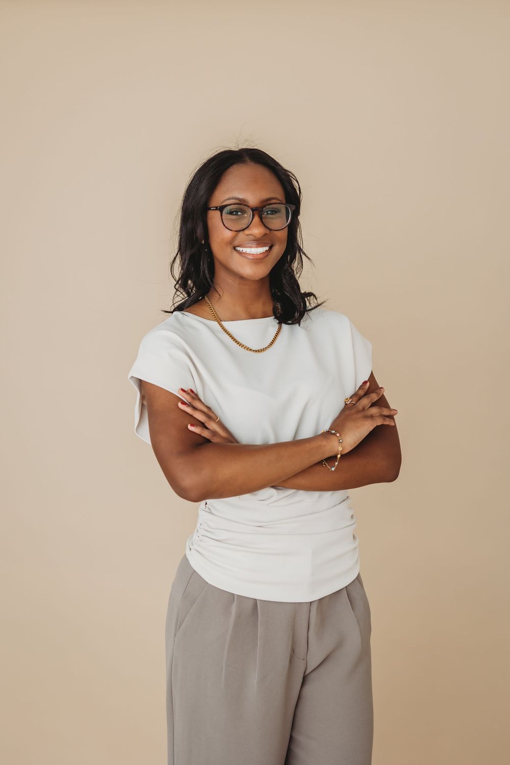 Casual business portraits featuring white t-shirt and taupe pants against neutral backdrop in New Haven, CT.