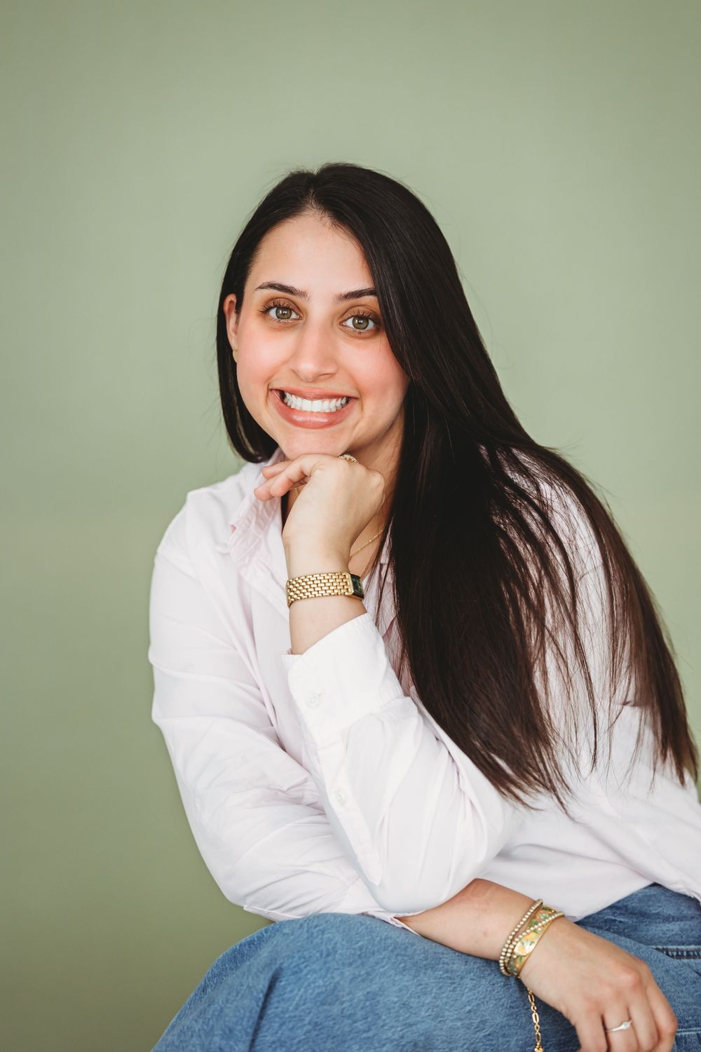 Portrait series against sage green background featuring casual white shirt and denim styling New Haven, CT.