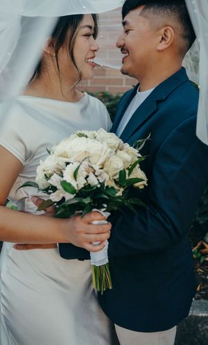 Under the veil bride and groom and bouquet elopement wedding