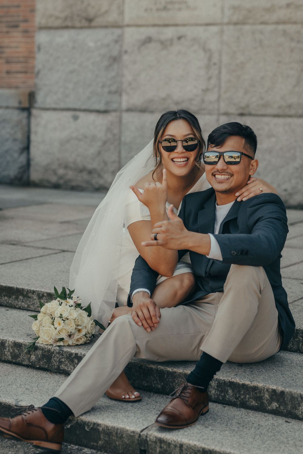 bride and groom at courthouse wearing sunglasses elopement wedding