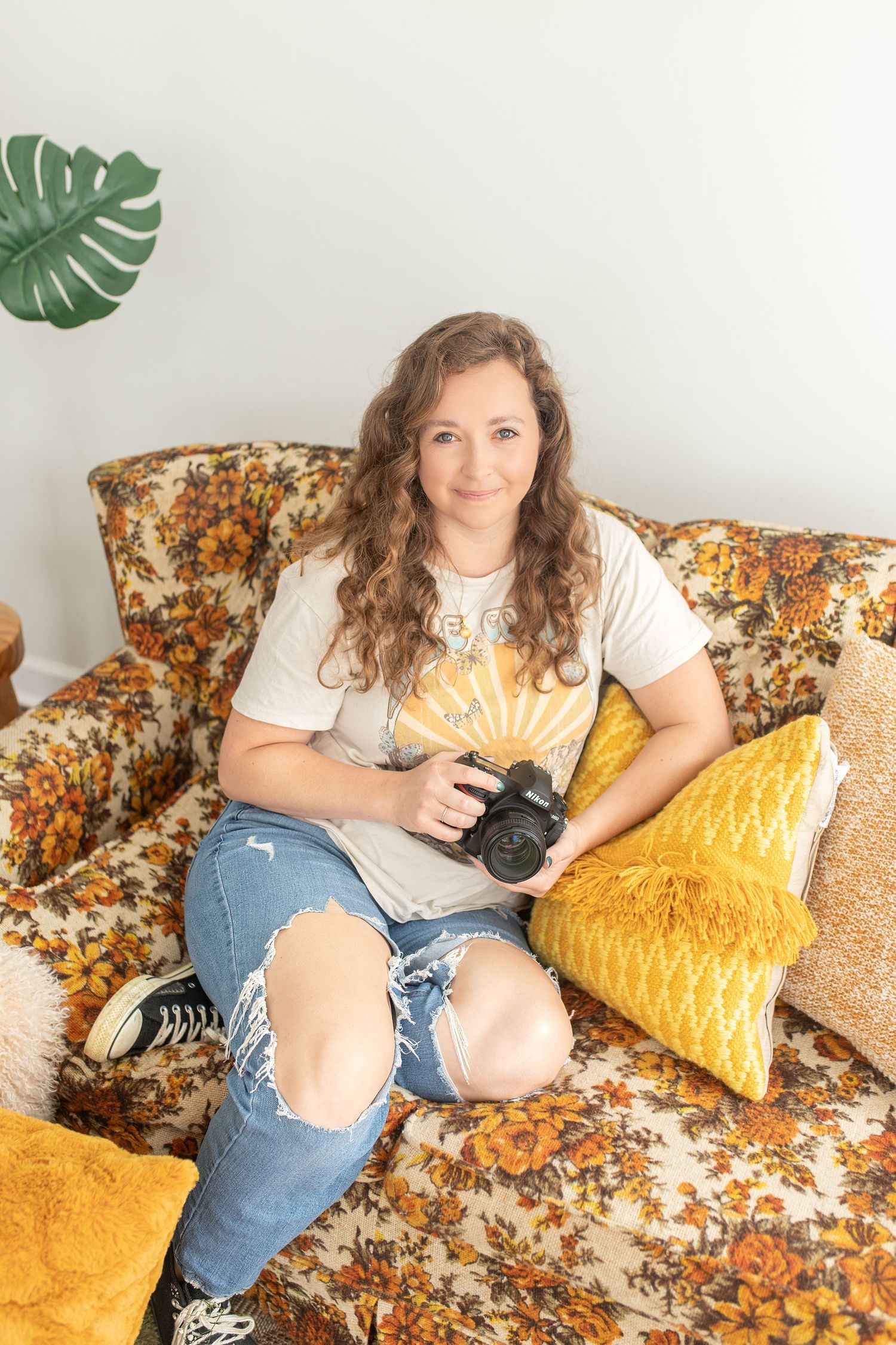 Photographer poses with camera as part of introductory get to know me page