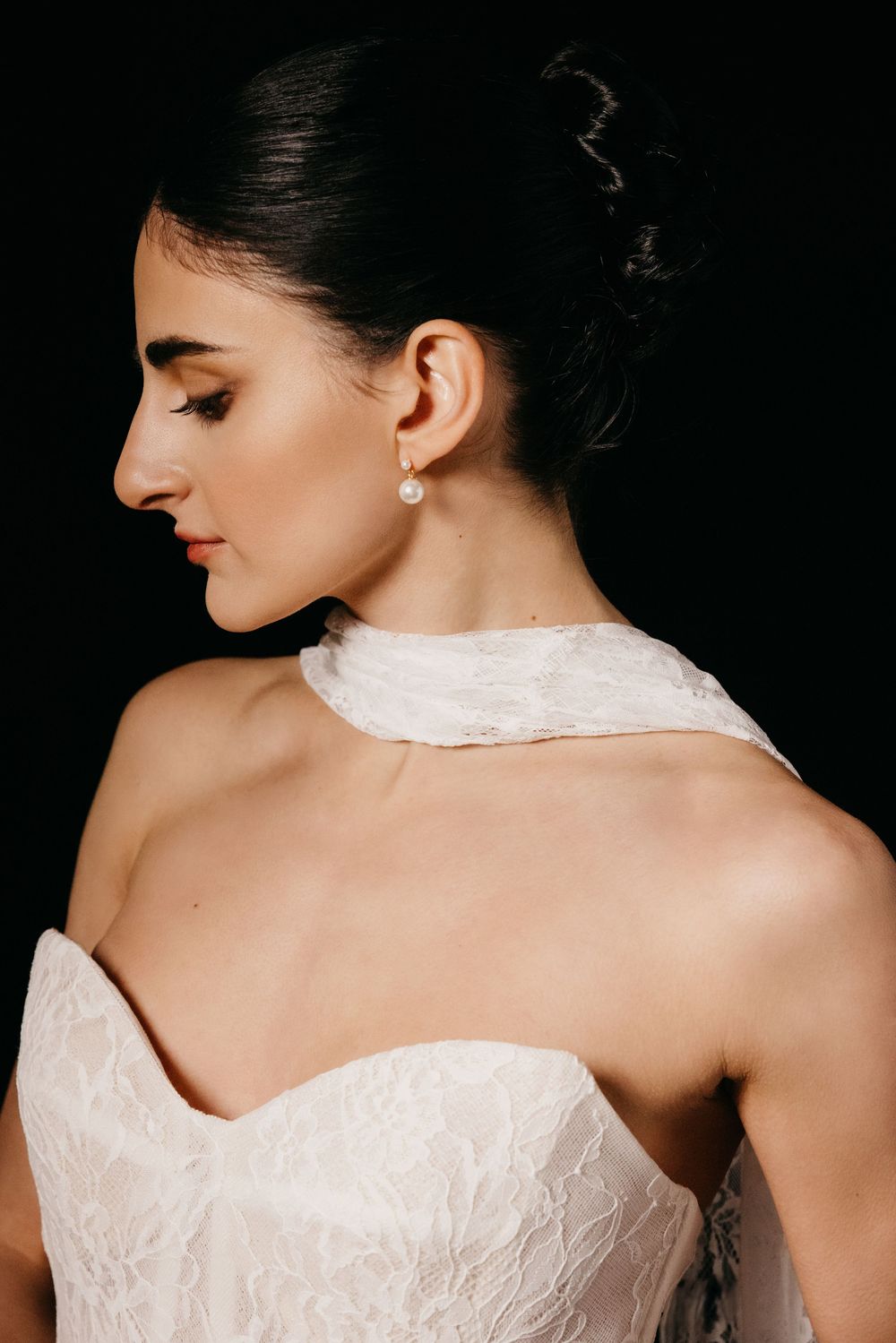 Editorial model wearing lace wedding gown with scarf on black backdrop, Atlanta editorial portrait and fashion photographer