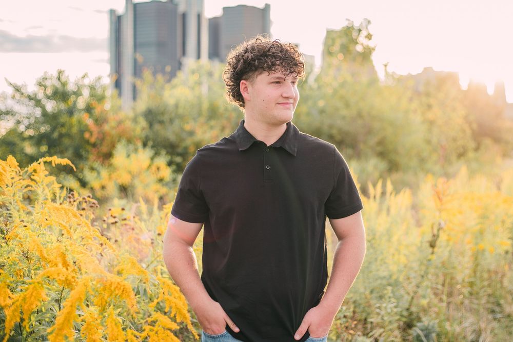 Senior photo in field of yellow flowers