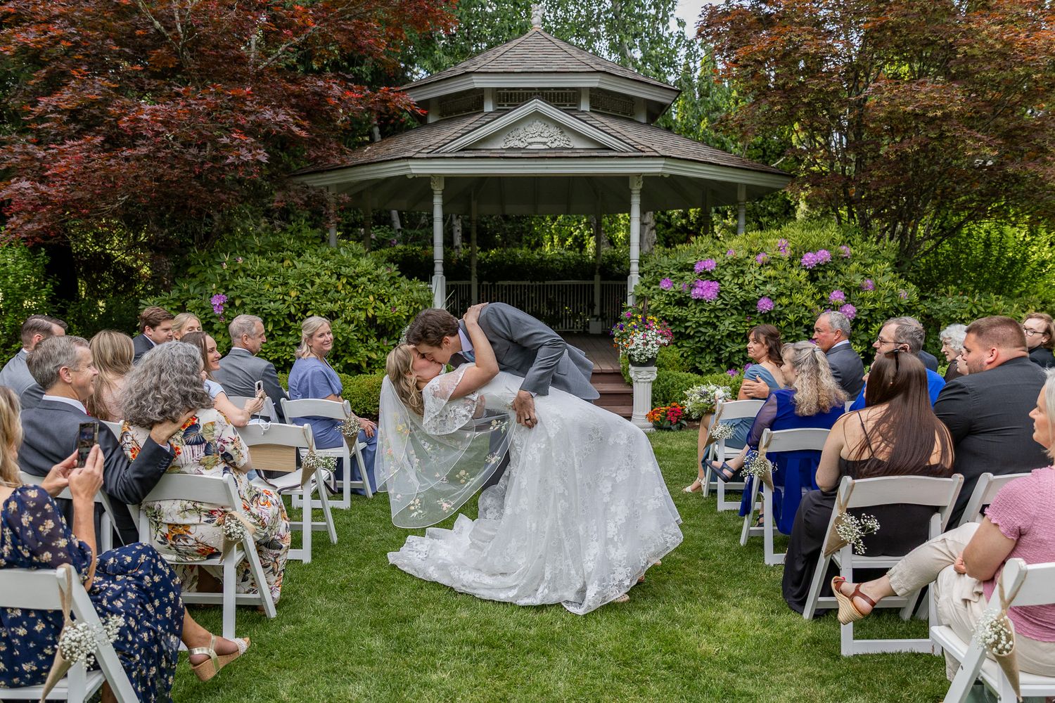 Bride and groom at the alter during their ceremony at Ogren Gardens in Eugene, Oregon, Captured by Oregon wedding photographer.