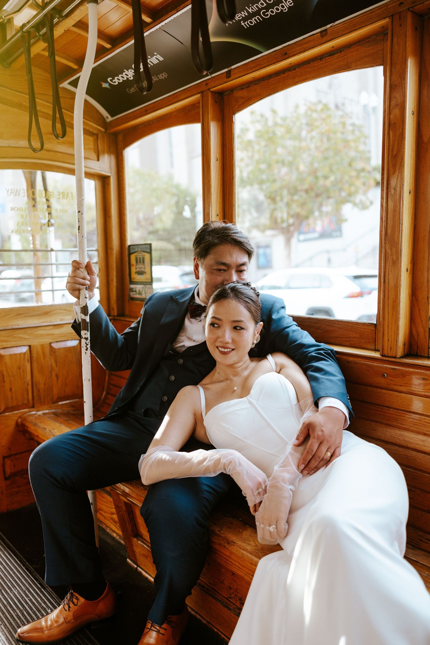 couple snuggling up in a cable car during san francisco elopement