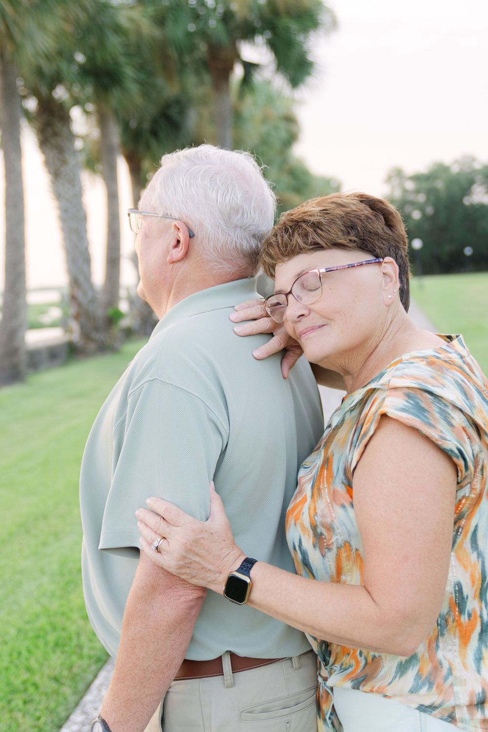 Couple shares a sweet moment beneath the oak trees during an anniversary portrait session with Lindy Rebro Photo