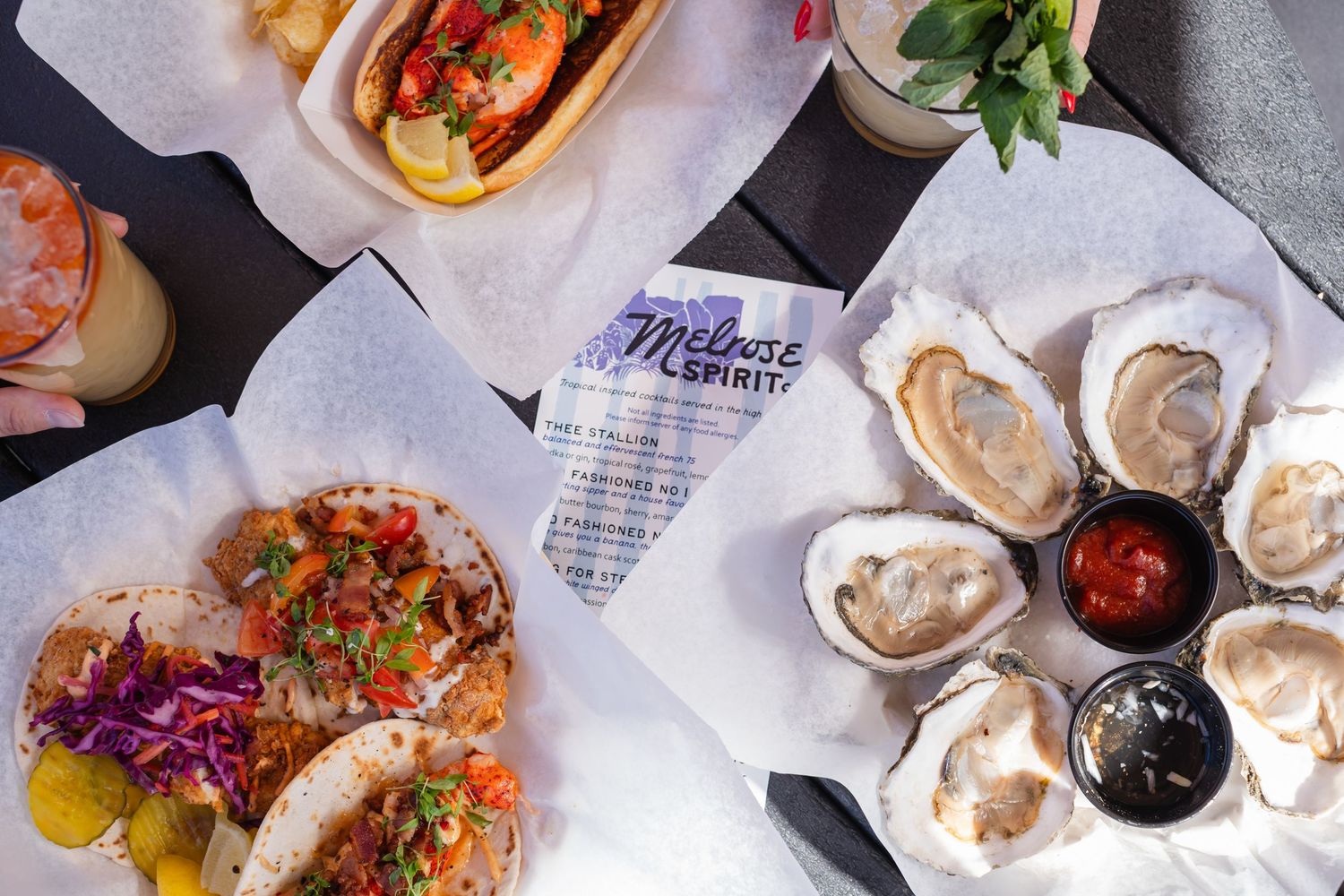 Plate with oysters, lobster roll and fish tacos
