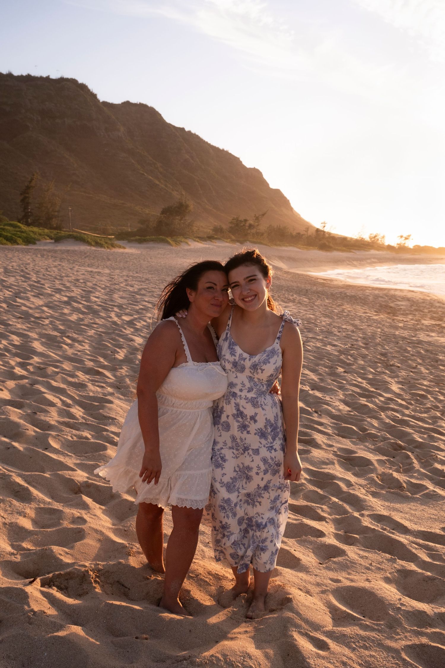 Mother and daughter sharing a quiet moment on a beautiful North Shore Oahu beach