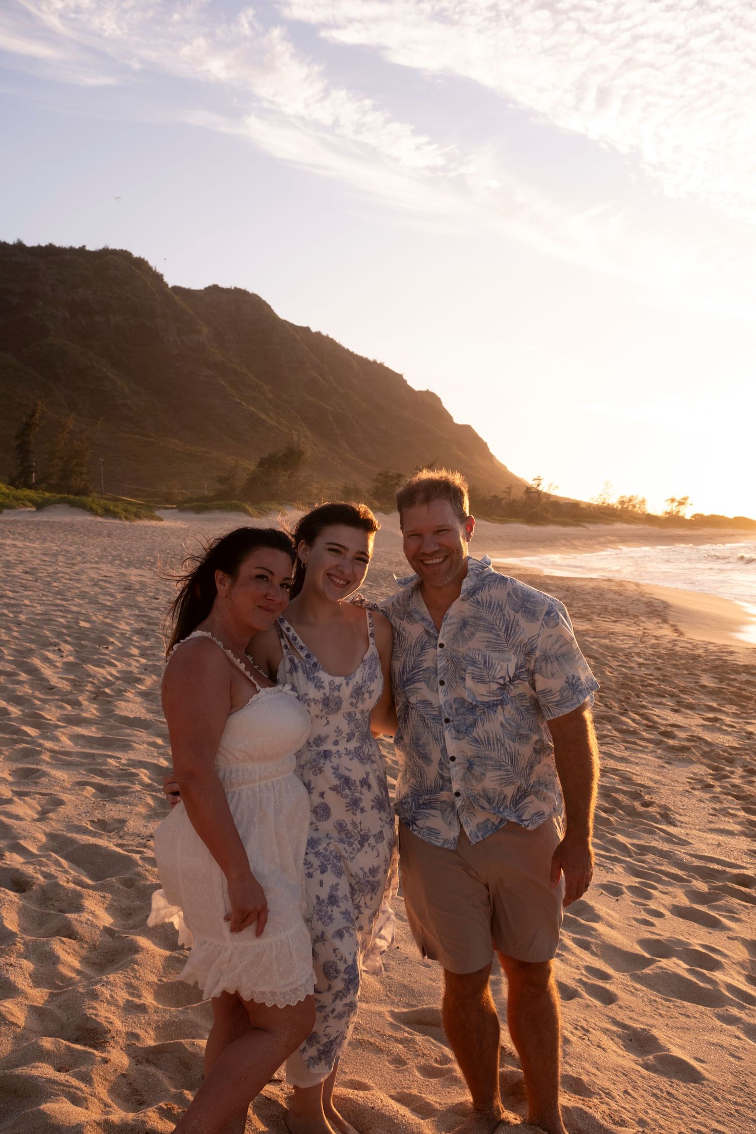 Family portrait beneath the mountains during a sunset photography session on North Shore Oahu