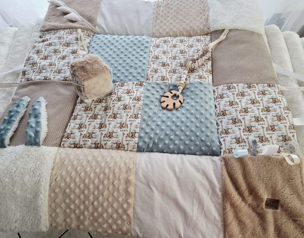 Handmade patchwork baby play mat with beige, blue, and brown minky fabric squares featuring bear prints.