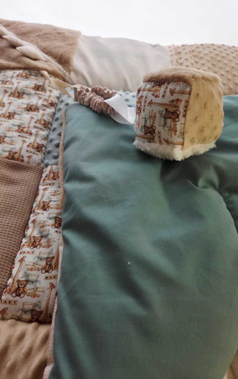 Baby nursery bedding set featuring teal, beige, and bear print fabrics with a soft minky cube toy.