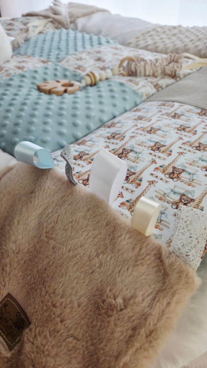 Handmade baby quilt with safari animal print, teal minky dots, faux fur, lace trim, and wooden teether toy.