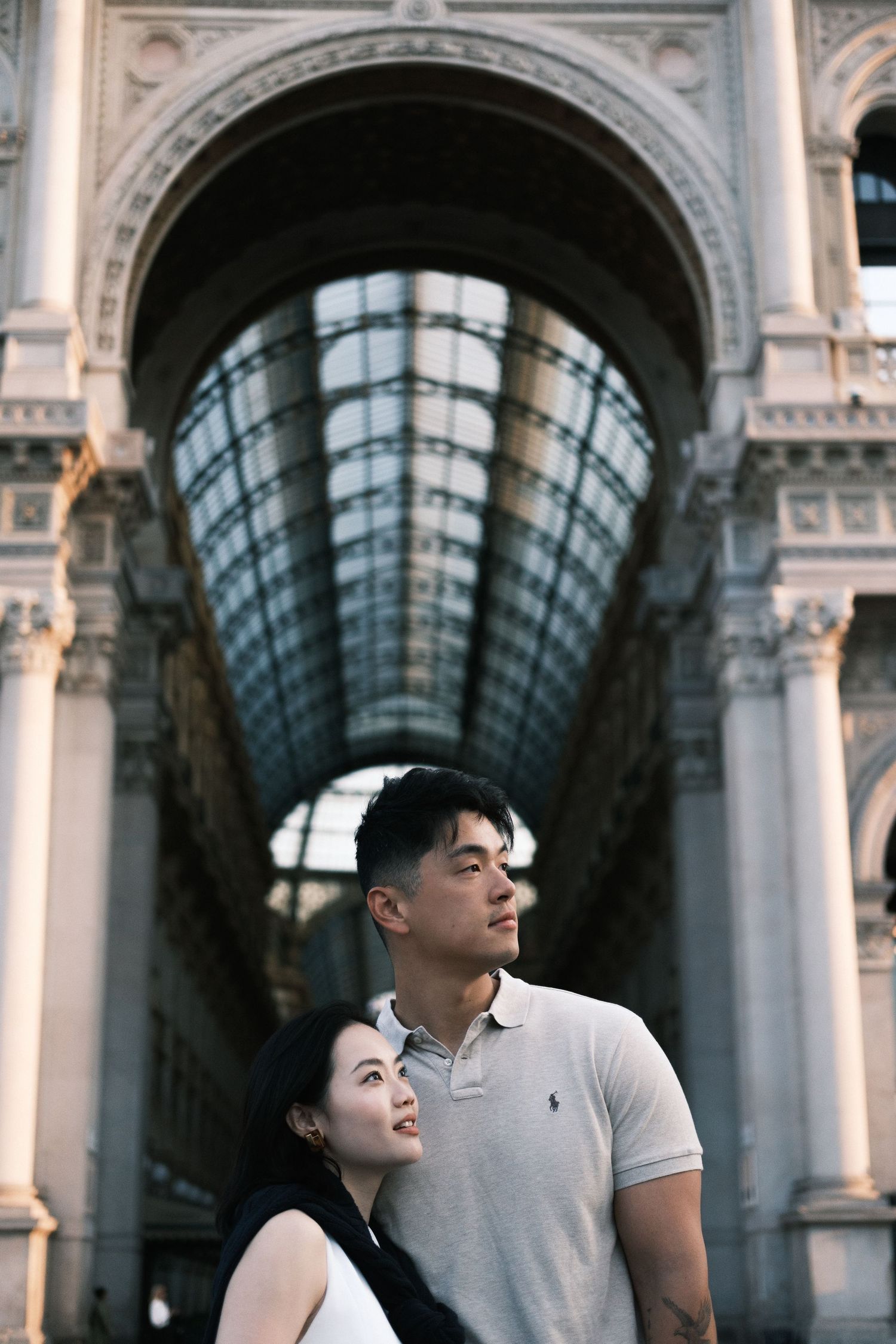 Couple's romantic proposal by a fountain with stunning Lake Como and mountain backdrop in Italy.
