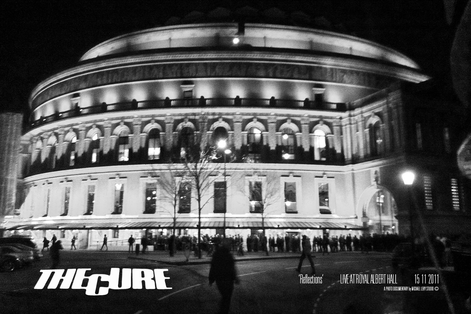The Cure Reflections live at Royal Albert Hall black and white night photo of illuminated historic building.