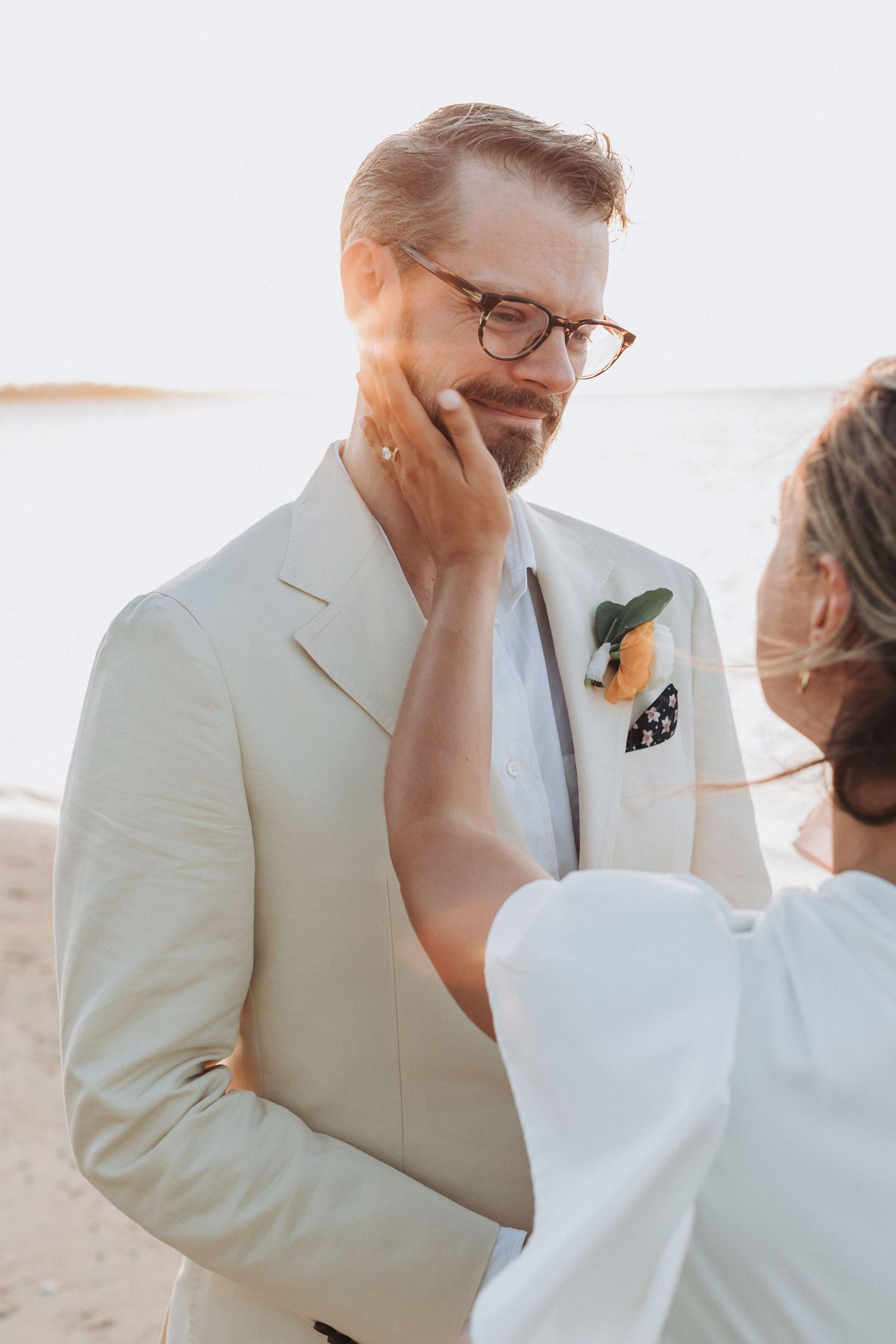 An intimate moment captured between a couple during their beach wedding ceremony.