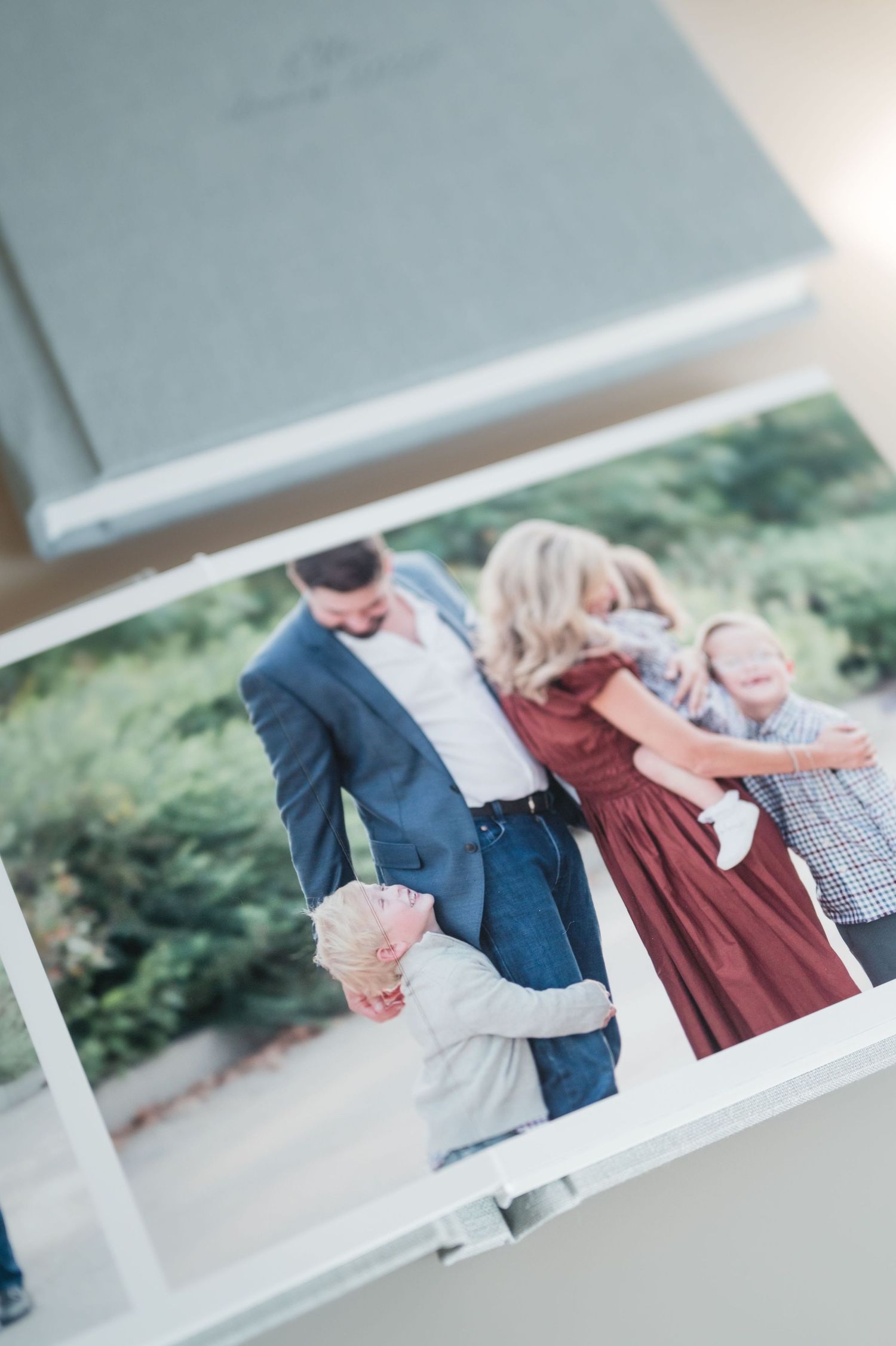 Linen photo album open to a candid family portrait