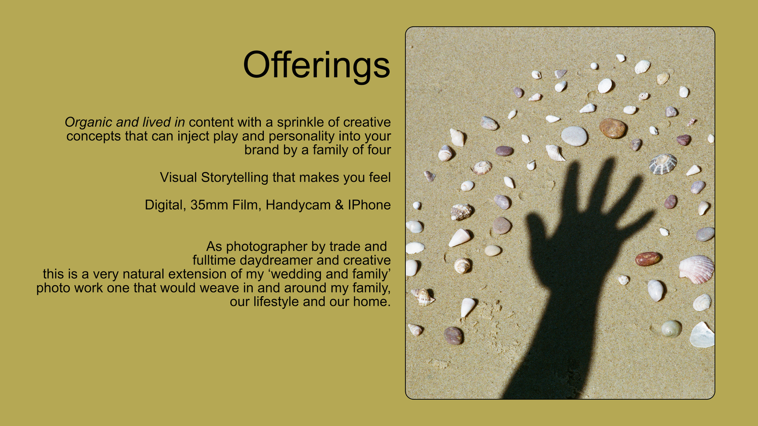 A hand shadow cast on sandy beach with scattered shells, alongside text describing photography and visual storytelling services.