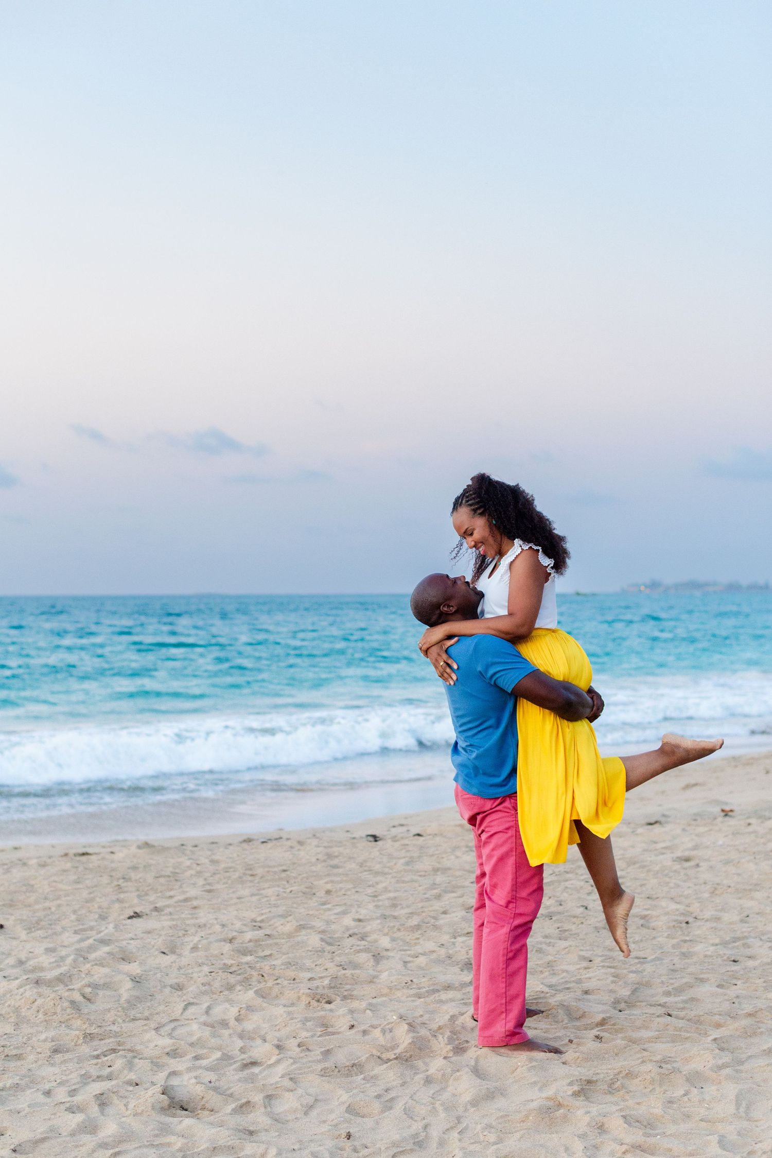 Couples portrait. Husband lifting wife on the beach in Isla Verde, Carolina, Puerto Rico.