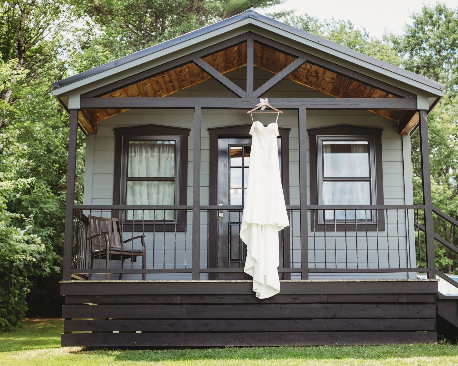 detail shot of dress hanging from the cabin you can get ready in at maine wedding venue in skowhegan maine