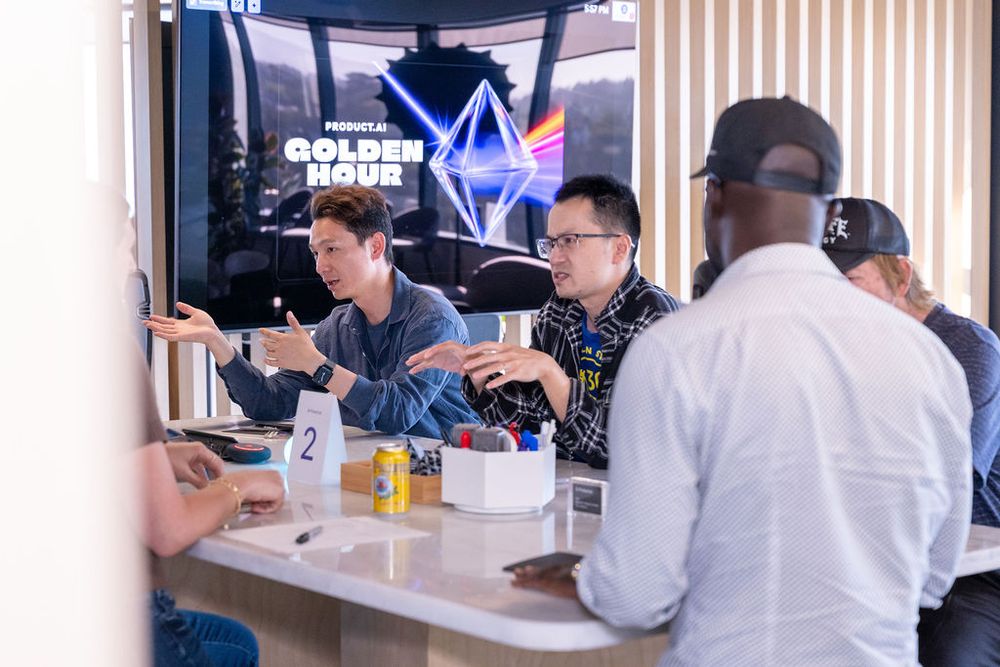 People networking at a Golden Hour event, gathered around a counter in conversation.