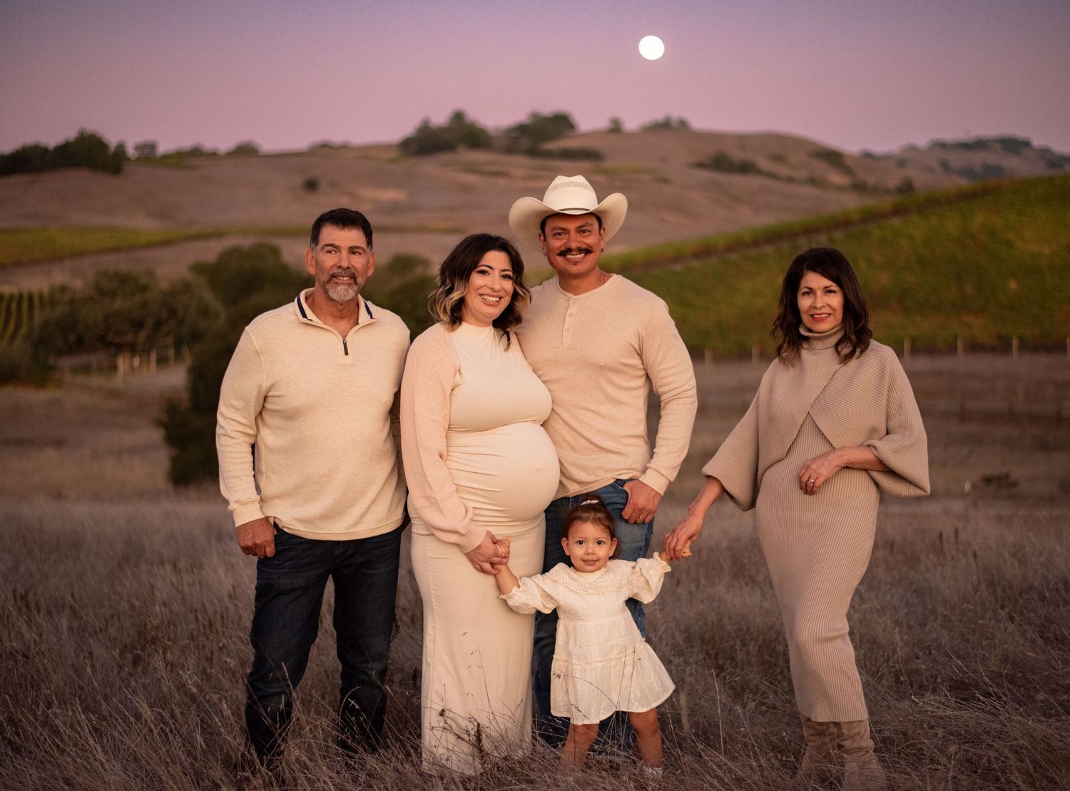 A family laughing and exploring together at Crane Creek, surrounded by open hills, tall grasses, and the beauty of Sonoma County.