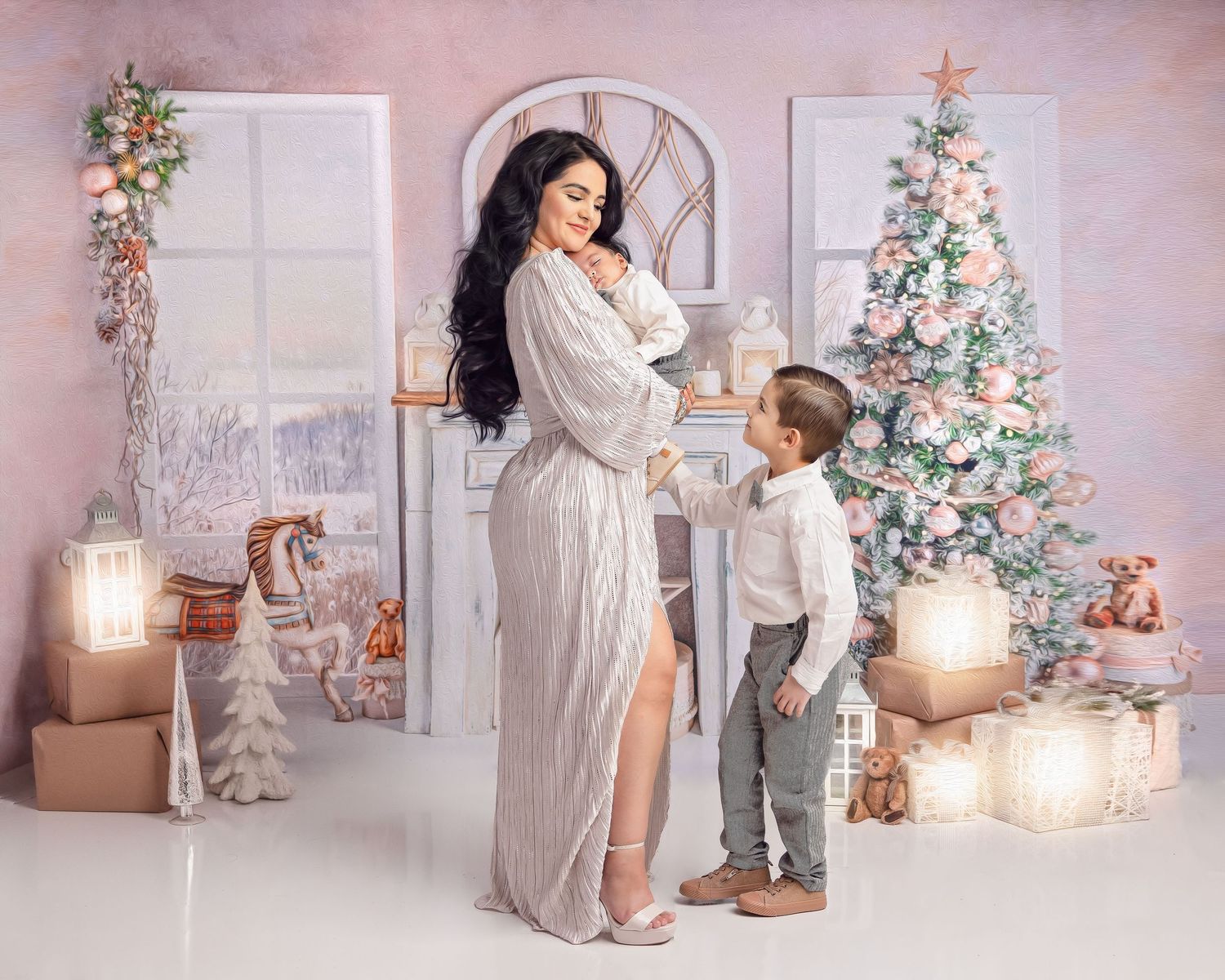 A woman in a white gown poses with a young boy near a decorated Christmas tree and gifts in a festive studio setting.