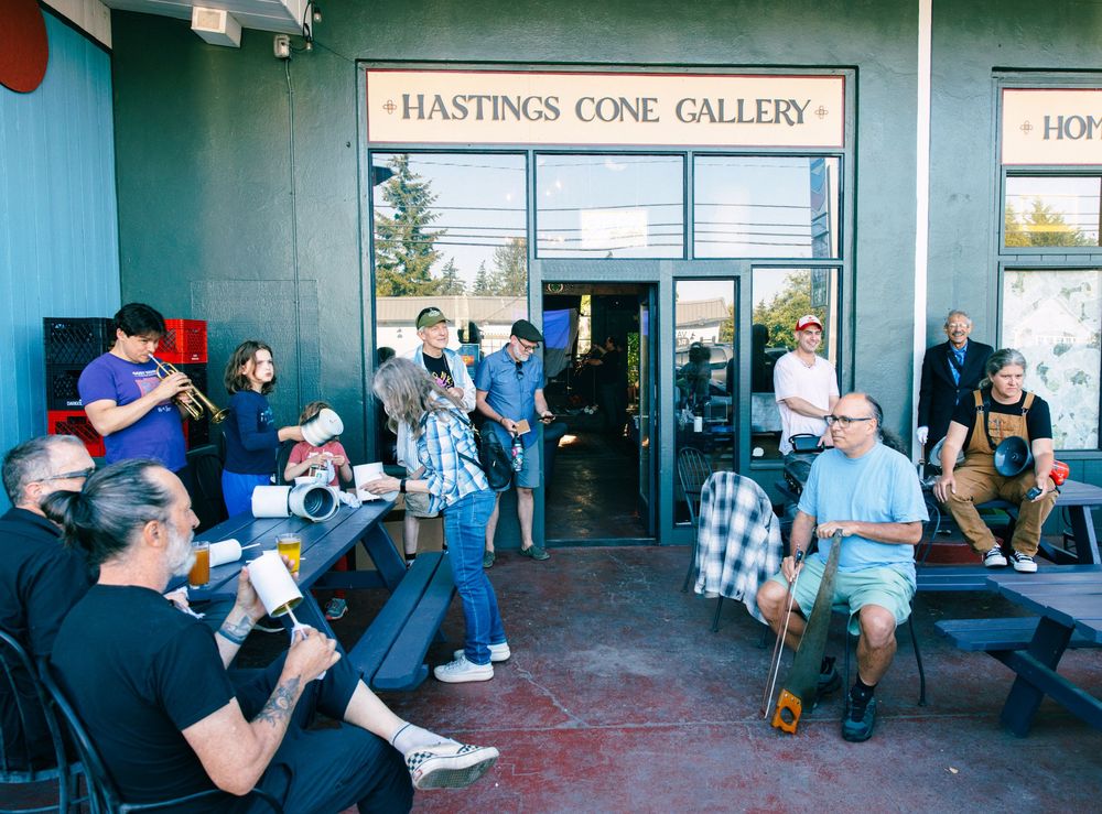 People enjoying ice cream outside Hastings Cone Gallery, a popular dessert shop with outdoor seating.