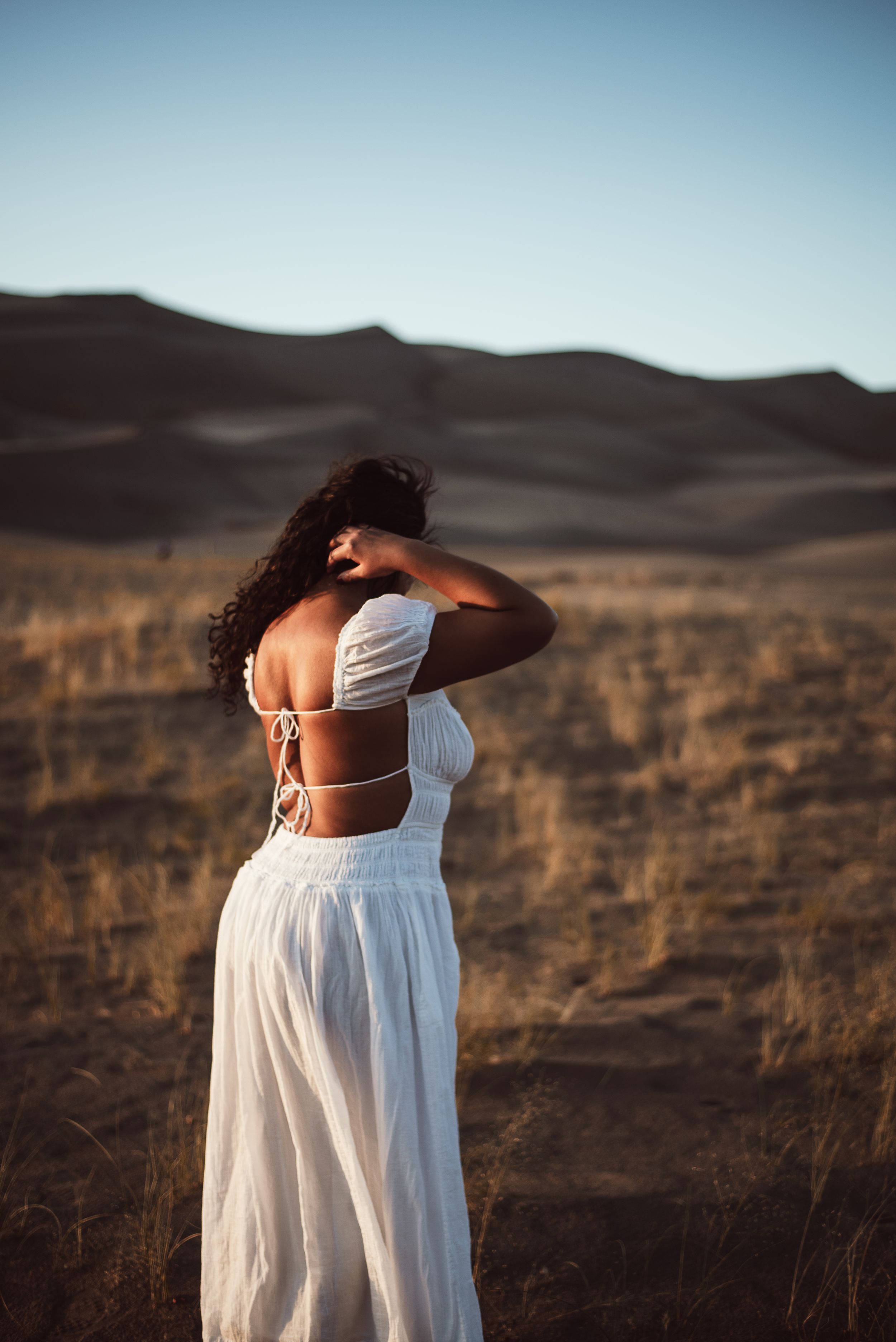 woman with white backless dress at the Great Sand Dunes near Pueblo, Colorado
