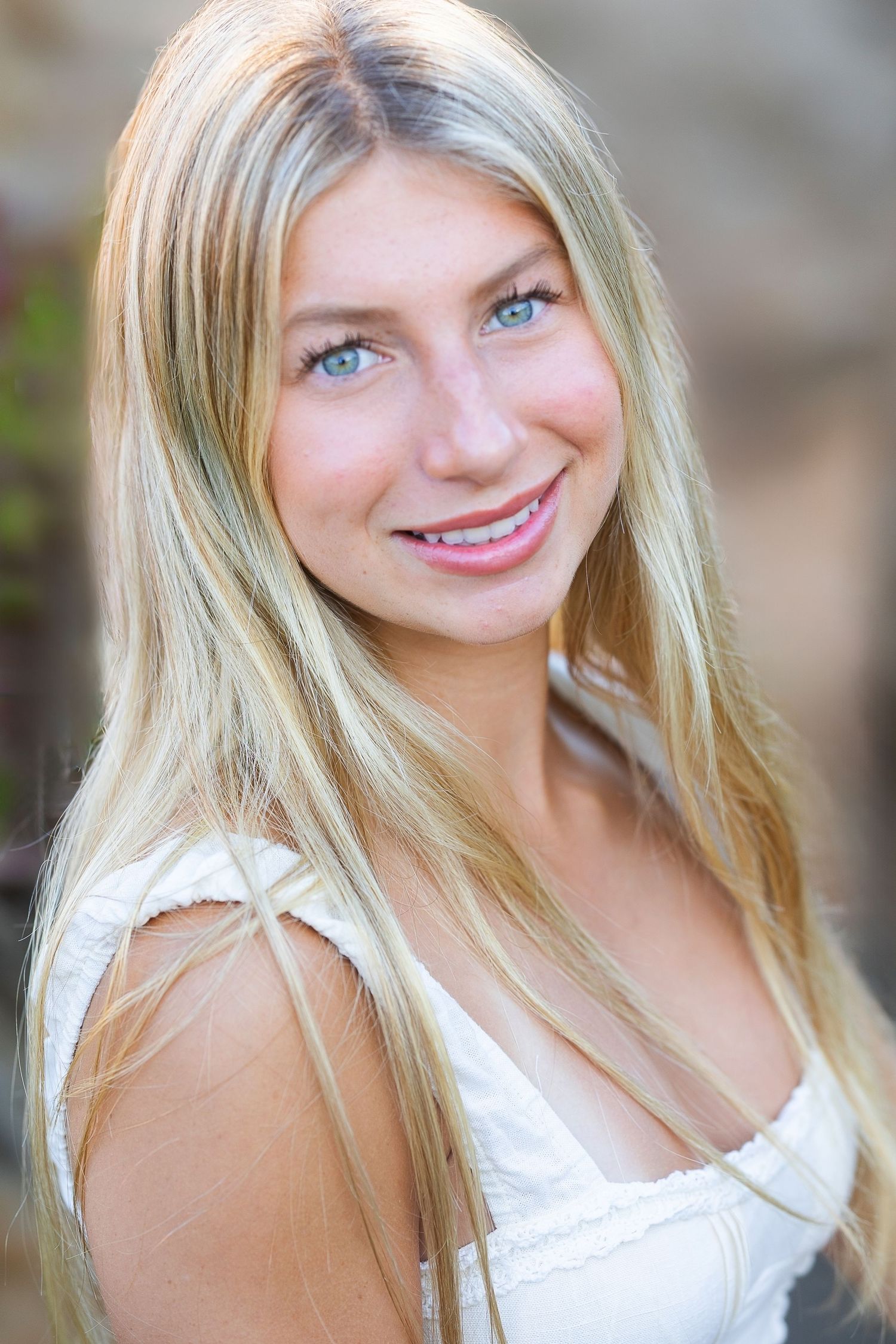 Pink banner advertisement with white text promoting exclusive senior photo sessions for Class of 2027.