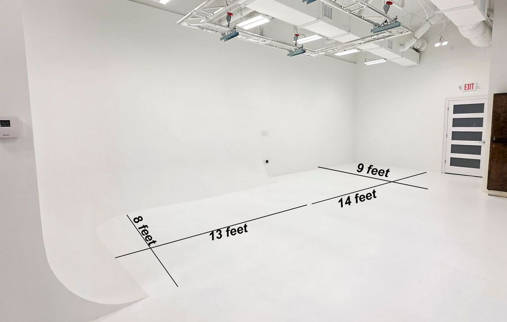 White infinity curved cyclorama studio with labeled dimensions: 8ft, 13ft, 14ft, and 9ft walls, featuring professional lighting rigs.