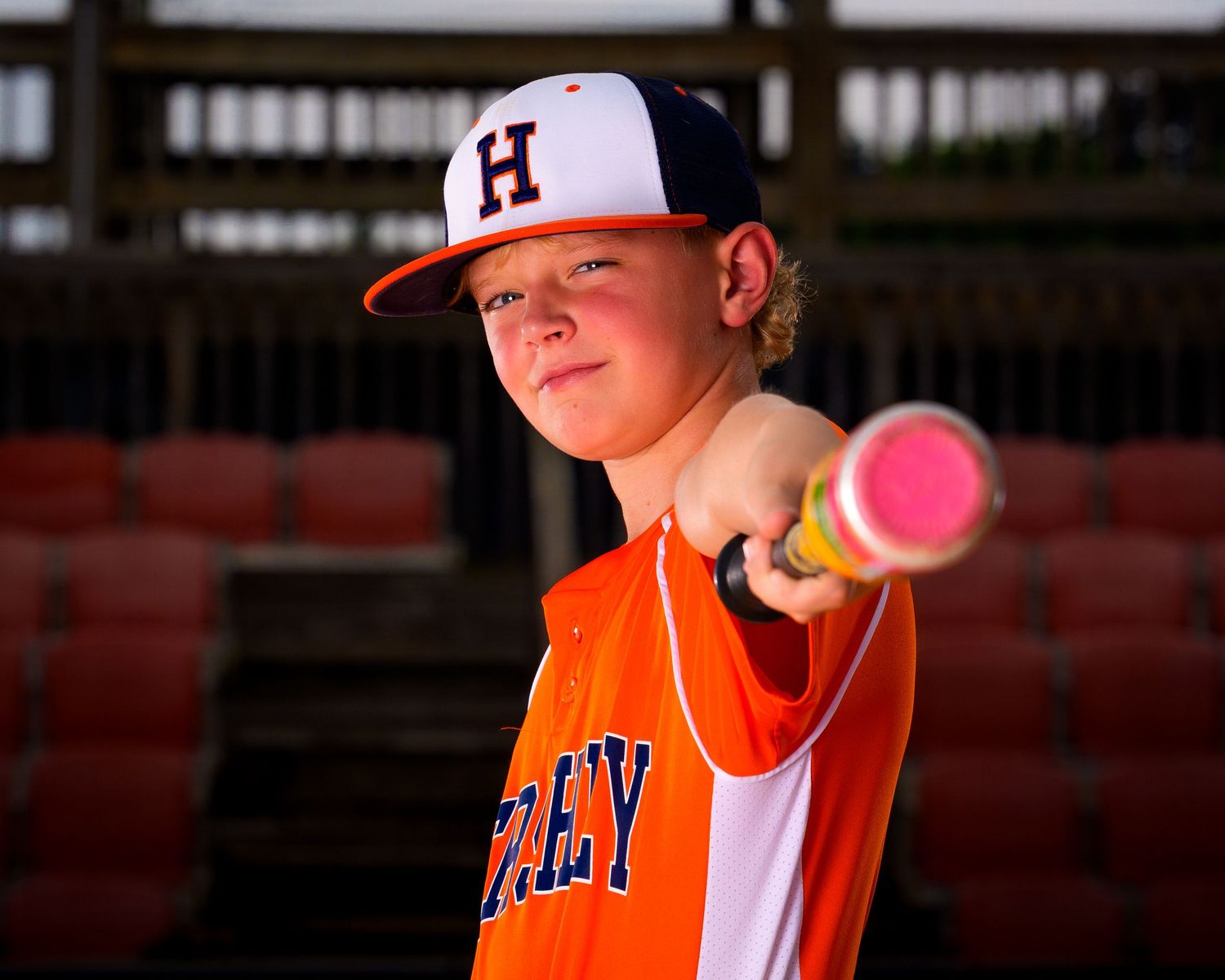 Hershey Little League player pointing bat for Media Day portrait, by Deanna Fox, SportsFox Photography, Hershey PA