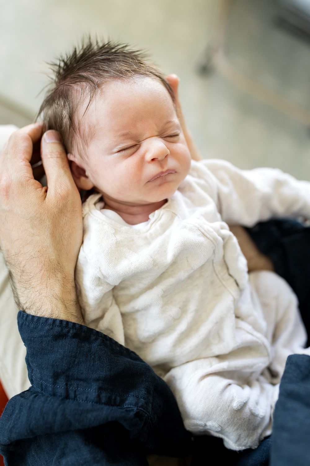 newborn baby girl scrunching up her face