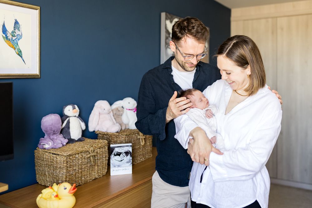 new parents holding their 3 week old baby girl