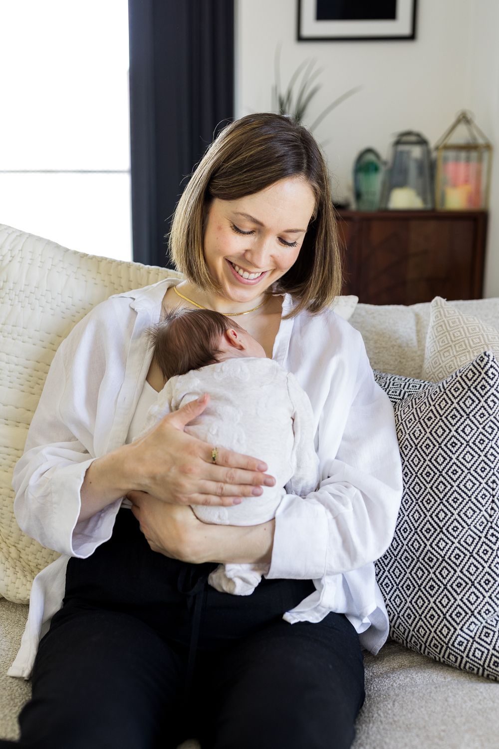 mum cuddling her newborn daughter at home in walthamstow