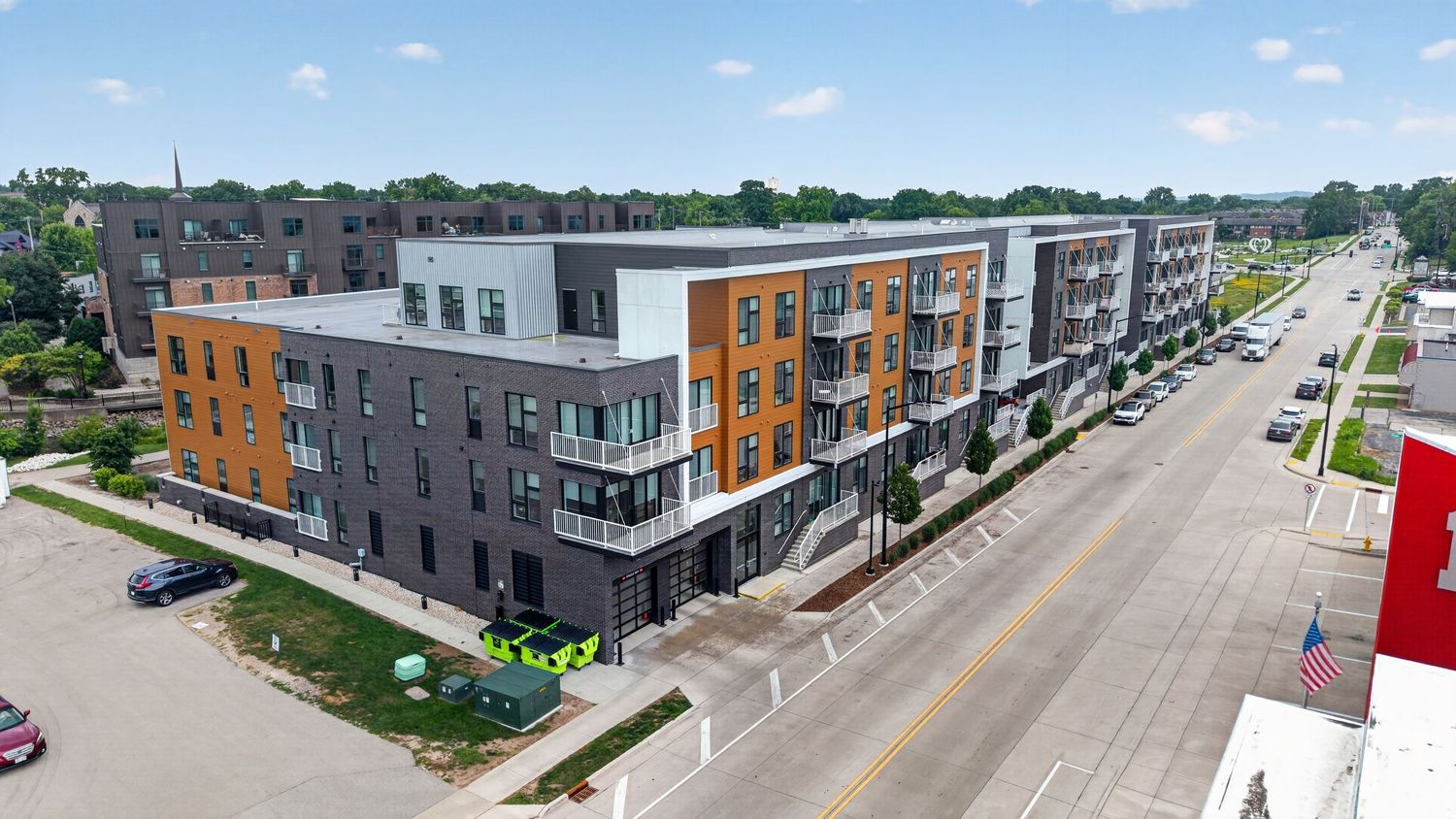 Aerial drone photo of a mixed-use apartment building along a Milwaukee area street