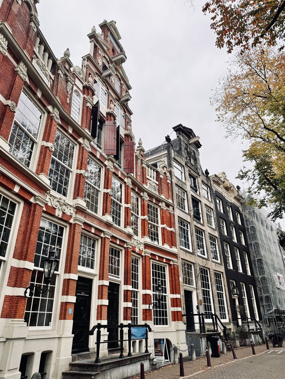 Historic Dutch Renaissance brick building with ornate facade and large windows in Amsterdam city center.