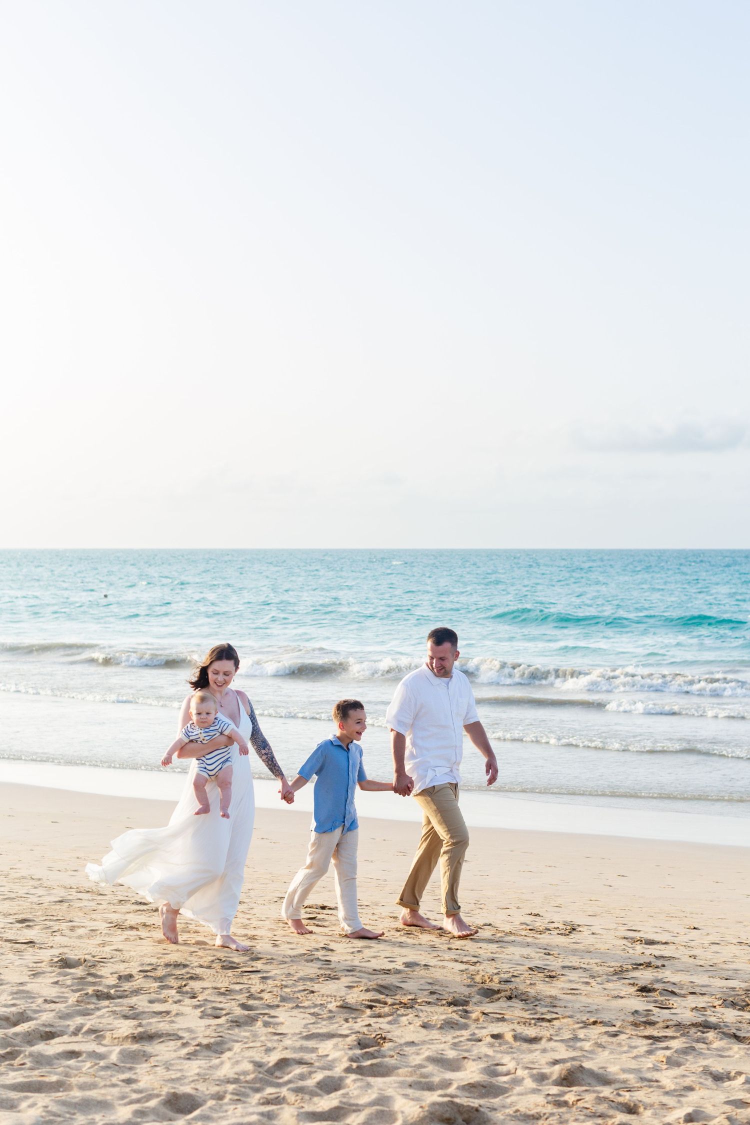 Family portrait on the beach in Isla Verde, Carolina, Puerto Rico. Father, mother and two sons.