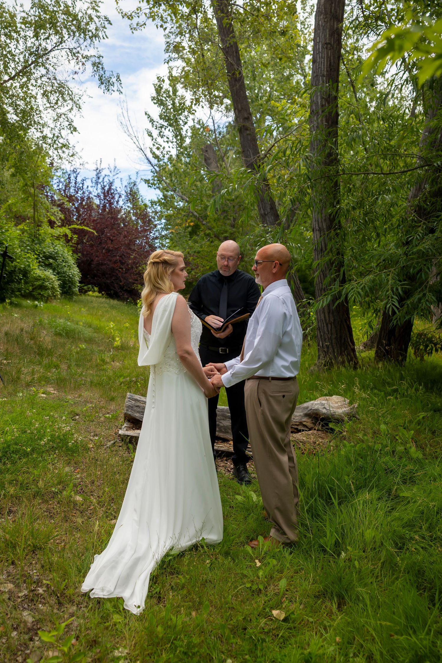 bride and groom exchanging vows in meadow Boise Idaho Elopement ©Milestones Studios LLC