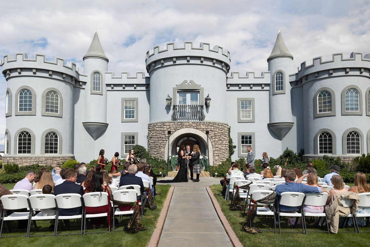 wedding ceremony in front of Castle Gardens Kuna Idaho ©MilestonesStudiosLLC Bride and groom walking up aisle after ceremony