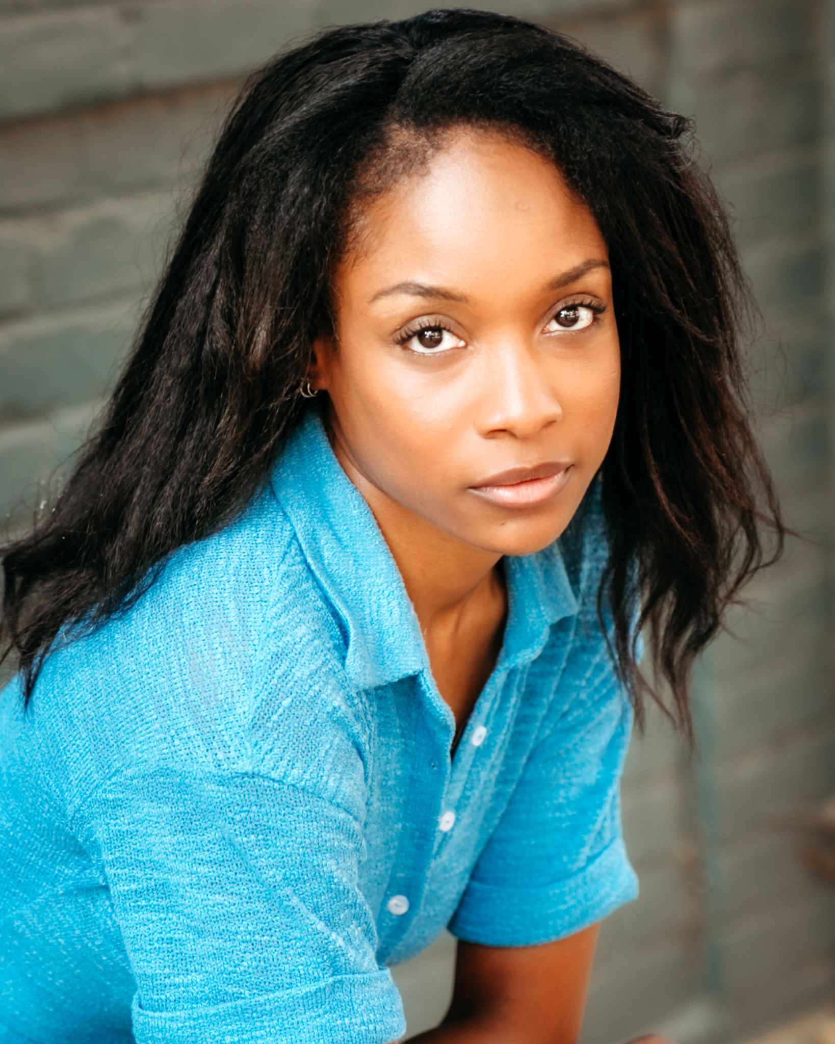 Commercial portrait of Genesis Dudley wearing a blue blouse.