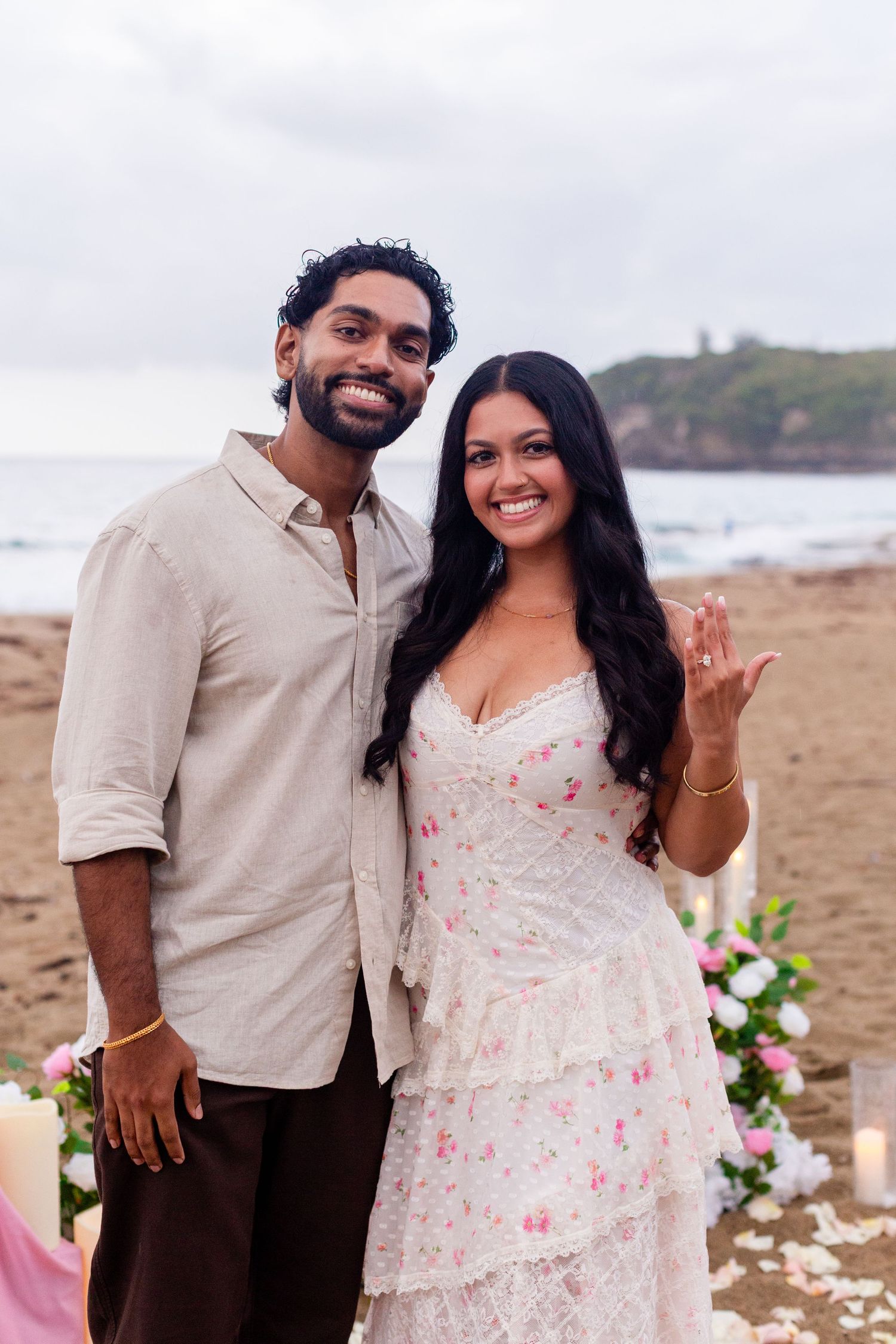 Marriage proposal on the beach with flowers and candles. Woman showing off the ring. Playa Guajataca, Isabela, Puerto Rico.