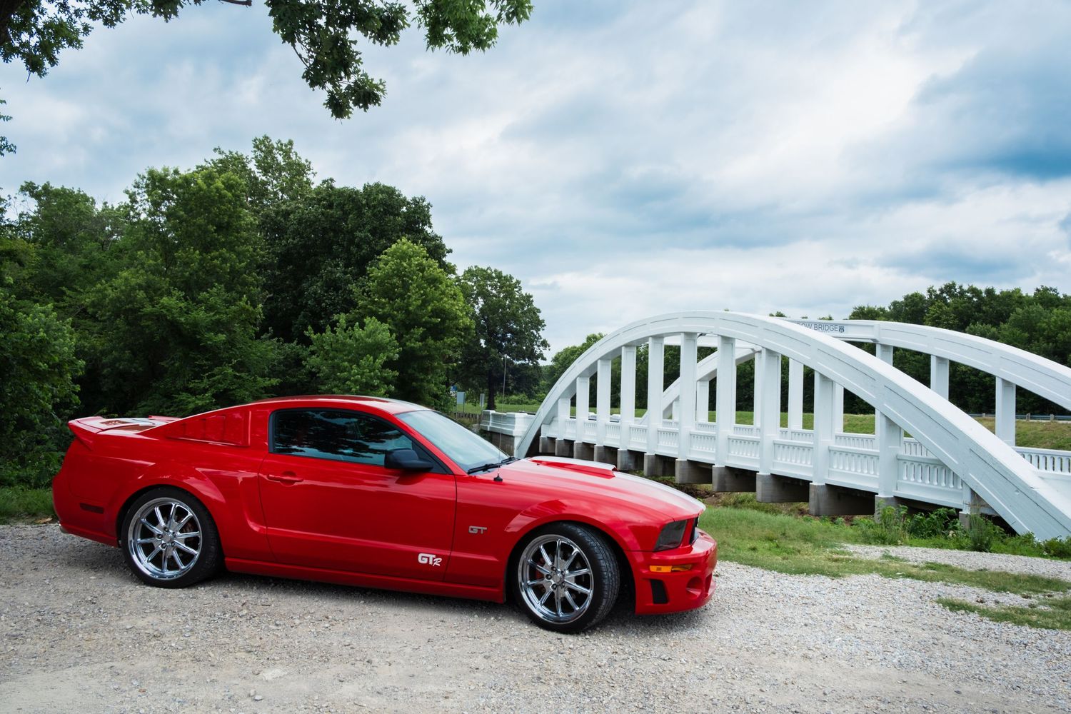 A red Ford Mustang and the Rainbow Bridge. Route 66, Kansas. June 11, 2026. David J. Manning.