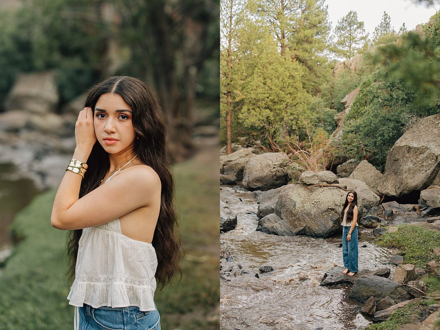 Young woman with long dark hair poses in white top and jeans by a rocky creek surrounded by lush green trees.