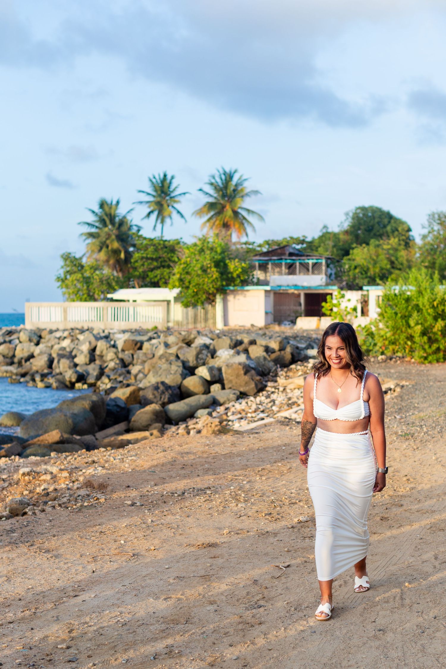 Marriage proposal overlooking the ocean in Río Grande, Puerto Rico. Woman walking up to the proposal setup.