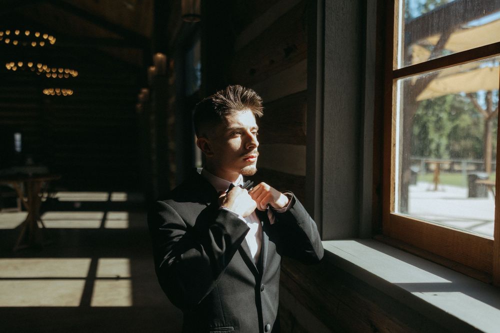 Groom getting dressed before Casa del Rio wedding ceremony