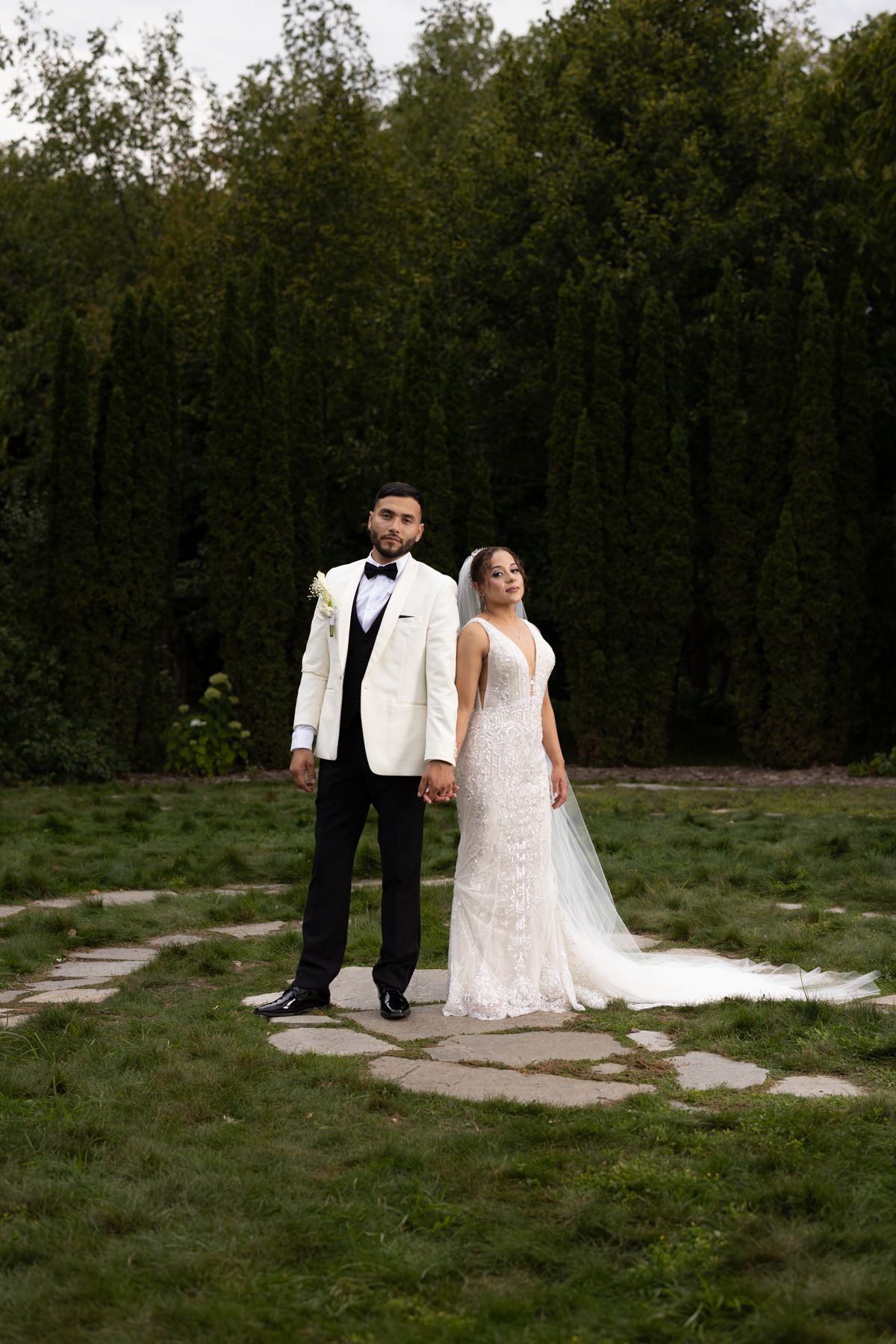 Bride and groom holding hands in a Millennium garden Plymouth Community Center Gerardo and Co. Photo by Gerardo Dominguez